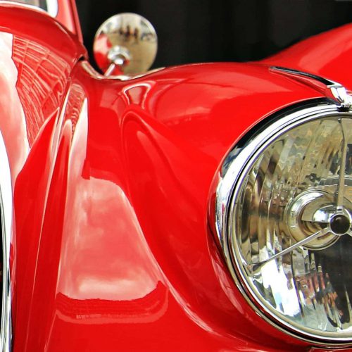 Canva - Headlight of a Classic Red Car